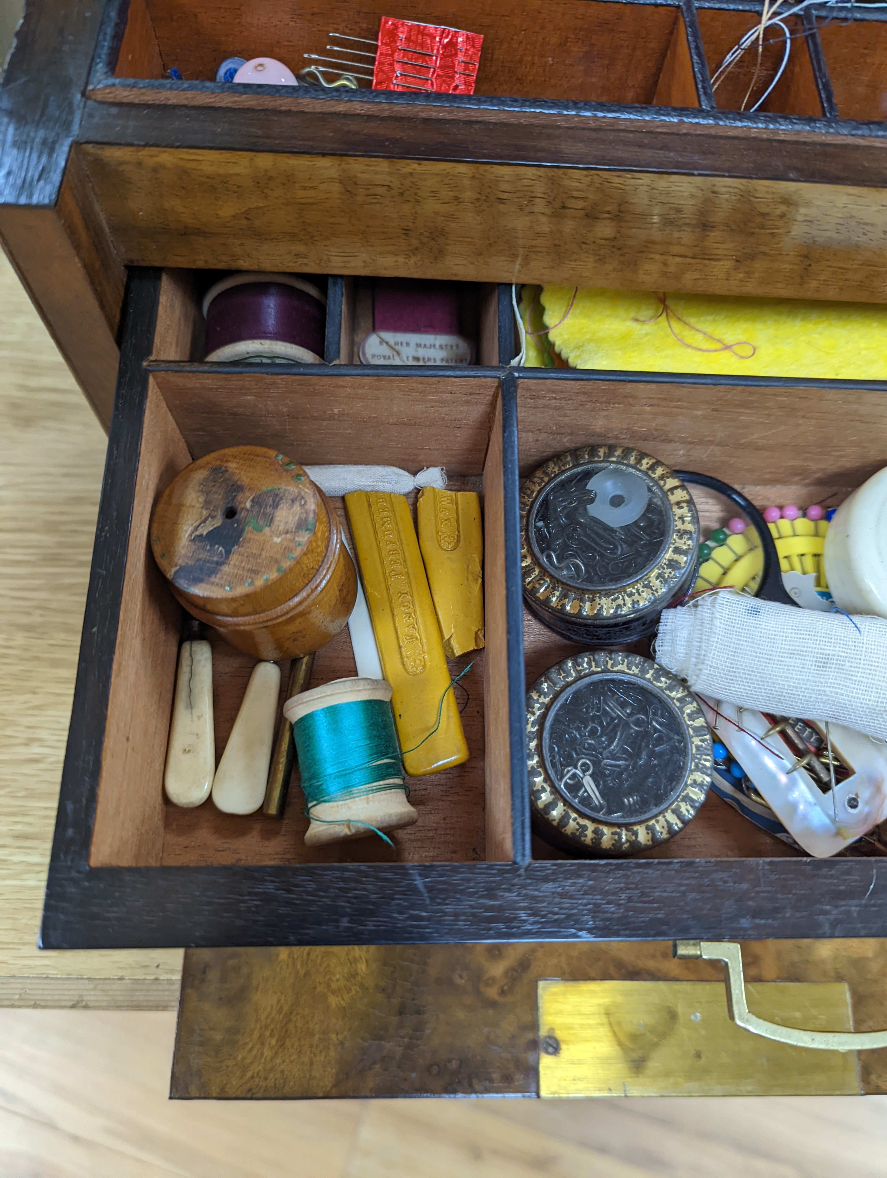 A Victorian walnut sewing casket, 34cm, containing sewing related accessories